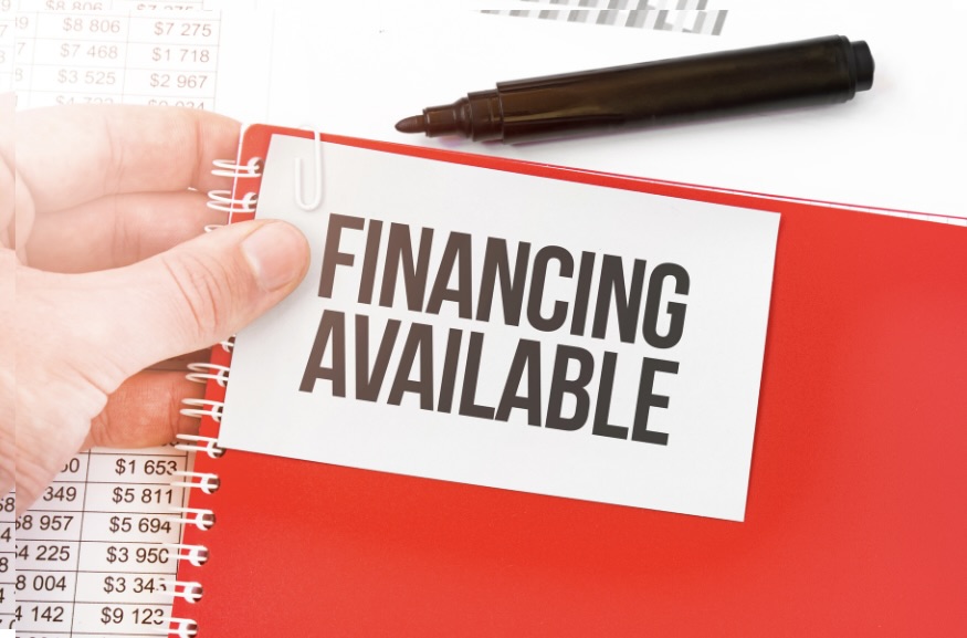 Untitled design – 1 A person holding onto a sign that says financing available